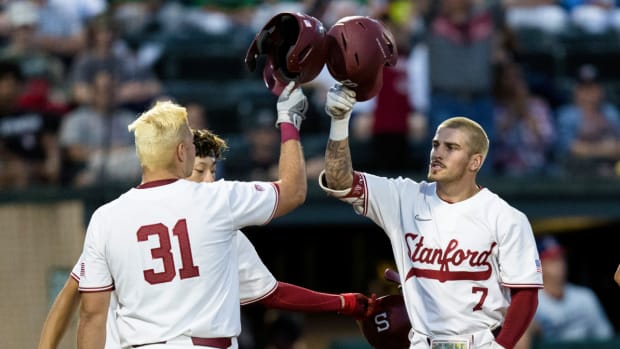 Stanford’s Brock Jones (7) celebrates with Carter Graham (31) after hitting a two-run home run against Connecticut during the second inning of an NCAA college baseball tournament super regional game Saturday, June 11, 2022, in Stanford, Calif.